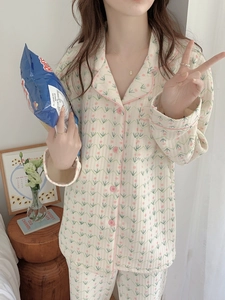 Detail of floral quilted pajamas set with pink piping and buttons for winter warmth