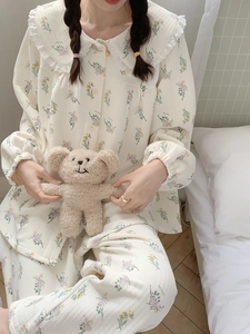 Detail of floral quilted cotton pajamas with lace doll collar and soft warm texture