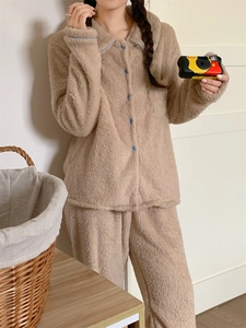 Detail of warm light brown double-sided fleece loungewear with blue buttons and cozy texture
