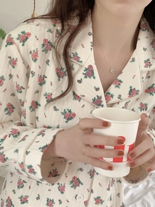 Detailed close-up of quilted floral pajama top with warm fabric and delicate pink flowers