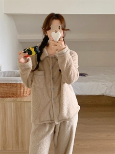 Close-up of beige thermal fleece pajamas set with blue buttons and contrast piping