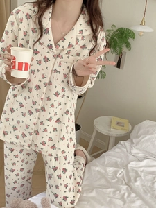 Close-up of floral print pajamas set featuring button-up collar and vintage cotton fabric