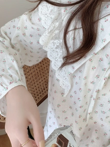 Close-up of elegant floral cotton nightdress featuring white lace collar and pink flowers