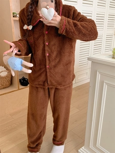 Detailed texture of brown plush winter pajamas featuring pink trim and button accents