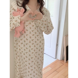 Floral cotton long-sleeve nightgown with lace collar for women in cozy home setting