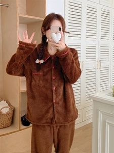 Detail of warm brown coral fleece pajama set with pink contrast trim and round buttons