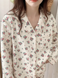 Close-up of beige quilted floral pajama top with pink rose patterns and soft texture