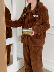 Detailed view of plush brown pajamas set with pink piping and soft coral fleece texture