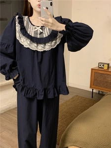 Detail of sweet lace collar and white bow on navy blue princess style pajamas set