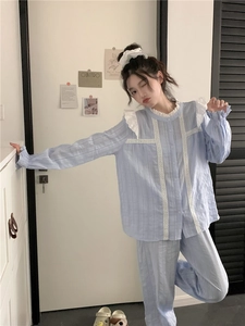 Detail of light blue pajama set featuring elegant white lace trim and ribbed texture fabric