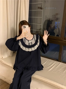 Detail of sweet dark blue pajama set with white lace collar and ruffled hem edges