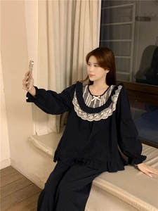 Close-up of sweet navy blue cotton pajamas with white lace collar and delicate bow details