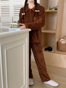 Detail of warm brown flannel pajamas featuring soft fleece fabric and pink trim detailing