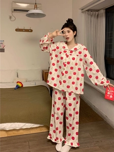 Detail view of cotton pajamas set featuring cute apple prints and Peter Pan collar
