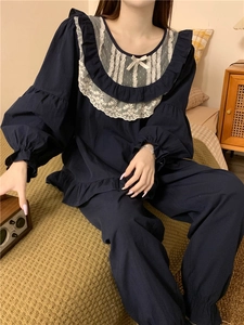 Close-up of sweet navy pajamas with white lace collar and beige bow detail