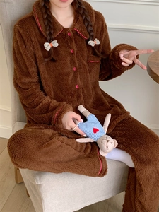 Detail of warm brown flannel pajamas with pink piping and buttons for winter comfort