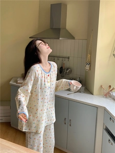 Détail du pyjama à fleurs avec bordures bleues et boutons colorés en gros plan