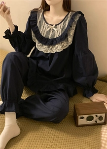 Detail of navy blue pajama set featuring sweet lace collar and elastic ruffled cuffs