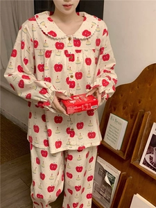Detail of cute long-sleeve pajama set with apple prints and lace Peter Pan collar