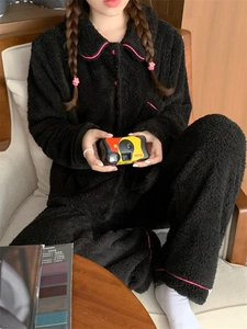 Detail of plush black thermal pajamas set with vibrant pink piping trim for winter