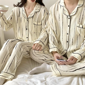 Close-up of beige striped pajama set texture and notched collar detail in a home setting