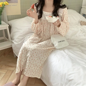 Dettaglio di camicia da notte vintage floreale con pizzo delicato e maniche lunghe