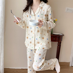 Close-up of yellow cotton pajama set featuring cartoon bears and floral print details