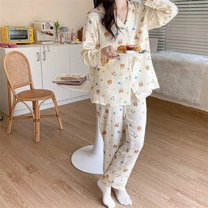 Women's pajama set featuring cartoon bear patterns and blue clouds in home setting