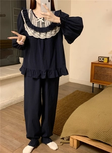 Detailed view of navy pajama set featuring white lace trim and bow accents on the neckline