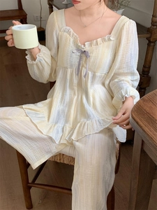 Detail of square neck ruffled pajamas with bow tie and striped texture for women