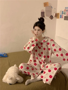Detail of sweet doll collar pajamas with cute apple print and ruffle trim edges