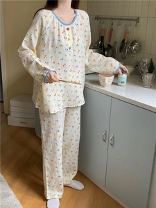 Détail du pyjama en coton à fleurs avec boutons colorés et bordure bleue contrastante