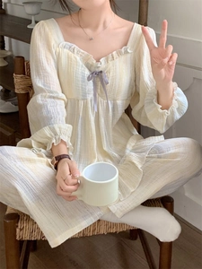 Detail of square collar loungewear set with ruffles and purple bow in light yellow plaid