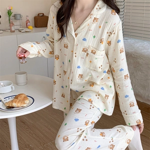 Detail of cream long-sleeved pajamas with cute bear prints and soft cotton gauze texture