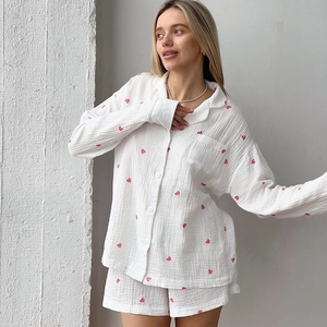 Women's white muslin pajamas set with red heart print featuring a button-down top and shorts