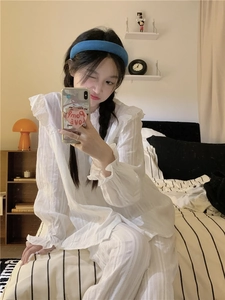 Close-up of the delicate white lace trim on the collar and ruffled cuffs of the pajamas