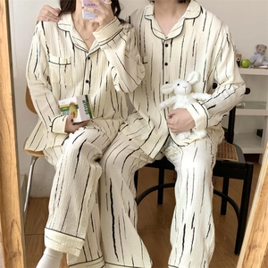 Detail showing the textured crinkle cotton fabric and black stripe pattern of pajamas
