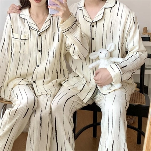 Close-up of black striped pajama details with cotton texture and contrast piping edges