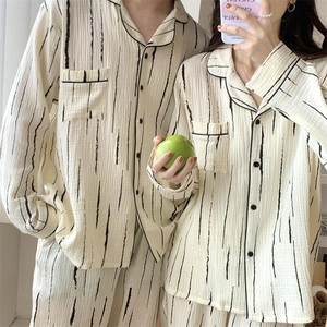 Detail view of striped couple pajamas set with lapel collar and button-down front
