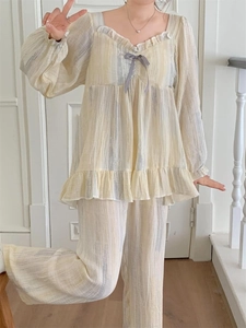 Detailed close-up of striped loungewear featuring ruffle trims and a cute ribbon bow