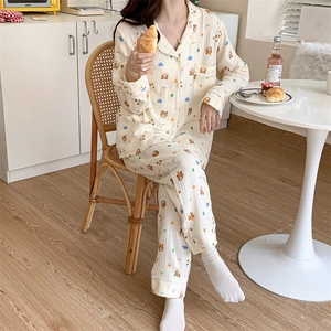 Detail of soft cotton gauze pajamas featuring cartoon bear prints and classic lapel design