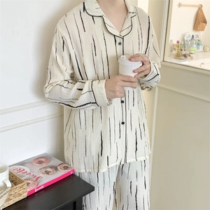 Detail view of striped pajama set showing the crinkle texture and lapel button-down design
