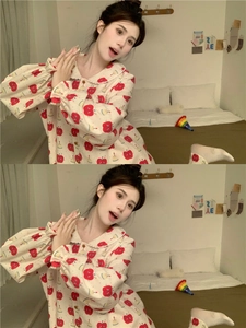 Detail of cute apple print loungewear set with ruffled collar in warm bedroom setting