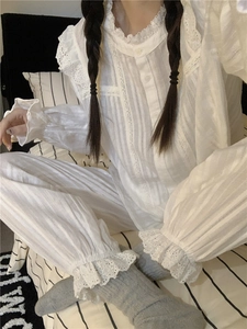 Close-up of white lace trim on vintage pajamas set with soft textured fabric details