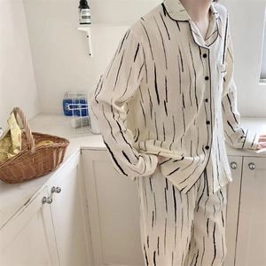 Detail view of cotton pajama set with black vertical stripes and piped notch collar