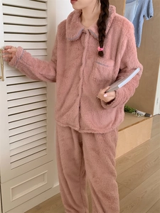 Detail of pink flannel pajamas showing contrast blue piping on the collar and pocket