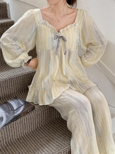 Detail of a two-piece home set with square neck ruffle design and grey bow accent