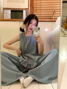 Detailed texture of blue-grey pleated cotton loungewear set with red ruffled hem