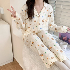 Detail of soft cotton long-sleeve pajama set with cute bear print and button-up front