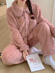 Detail view of pink fleece pajama set featuring blue piping and soft plush texture